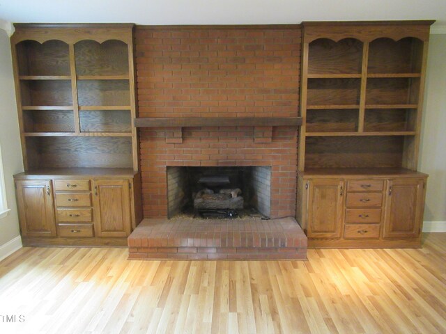 819 Patterson Grove Rd, Ramseur, NC 27316 - unfurnished living room featuring light wood-style flooring, baseboards, and a fireplace