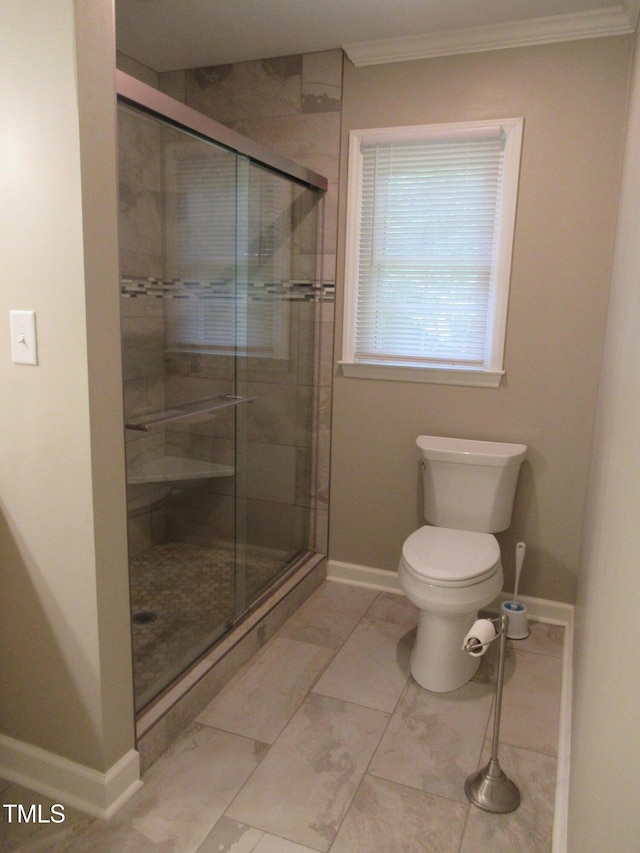 819 Patterson Grove Rd, Ramseur, NC 27316 - full bathroom with a stall shower, baseboards, ornamental molding, toilet, and marble look tiles