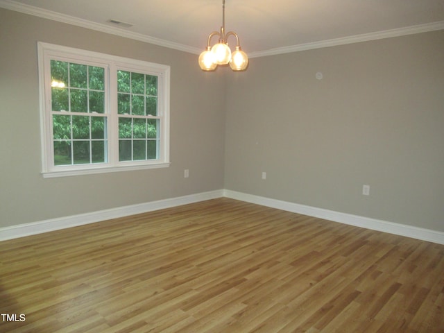 819 Patterson Grove Rd, Ramseur, NC 27316 - spare room featuring light wood-style floors, ornamental molding, a chandelier, and baseboards