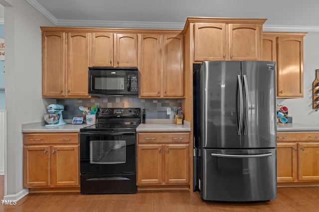 2012 Sterling Hill Dr, Fuquay Varina, NC 27526 - kitchen featuring black appliances, light countertops, wood finished floors, crown molding, and decorative backsplash
