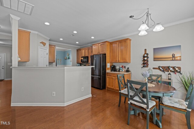 2012 Sterling Hill Dr, Fuquay Varina, NC 27526 - kitchen featuring black appliances, crown molding, recessed lighting, wood finished floors, and a chandelier