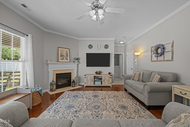 2012 Sterling Hill Dr, Fuquay Varina, NC 27526 - living area with a ceiling fan, ornamental molding, a fireplace with flush hearth, wood finished floors, and baseboards