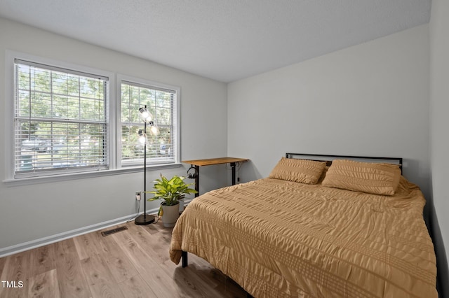 145 Coleridge Ct, Carrboro, NC 27510 - bedroom with multiple windows, wood finished floors, and baseboards