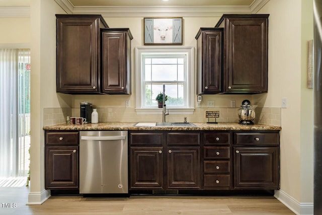 kitchen with stainless steel dishwasher, a sink, dark brown cabinets, decorative backsplash, and crown molding