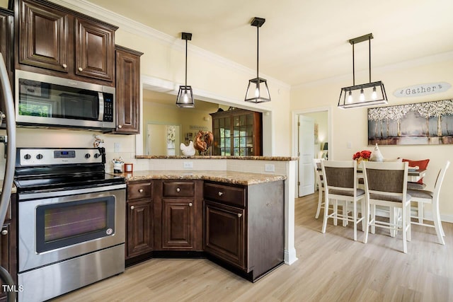 kitchen featuring appliances with stainless steel finishes, light wood-type flooring, a peninsula, dark brown cabinets, and ornamental molding