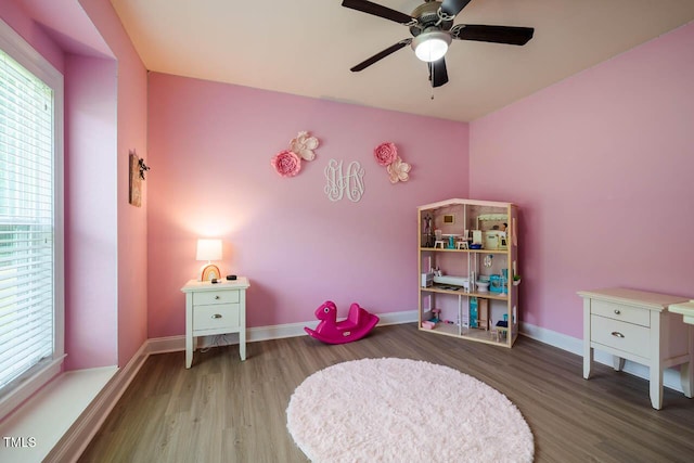 game room with wood finished floors, baseboards, and ceiling fan