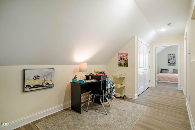 office featuring wood finished floors, vaulted ceiling, and baseboards