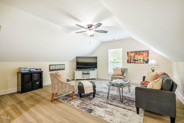living room with wood finished floors, vaulted ceiling, a ceiling fan, and baseboards