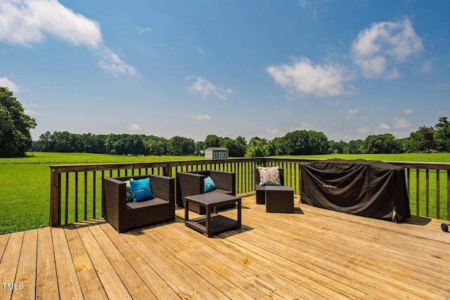 wooden deck with an outbuilding, a lawn, a storage unit, and view of scattered trees