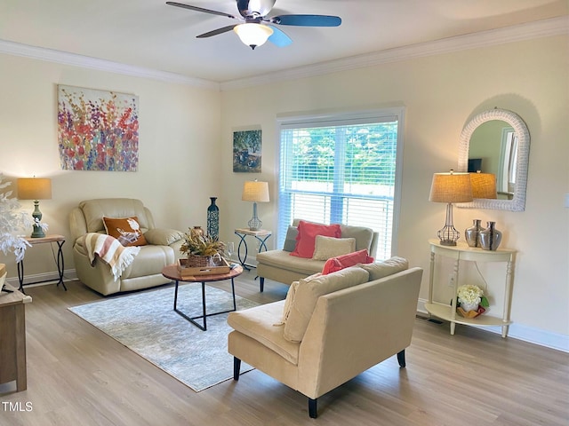 living area featuring wood finished floors, a ceiling fan, crown molding, and baseboards