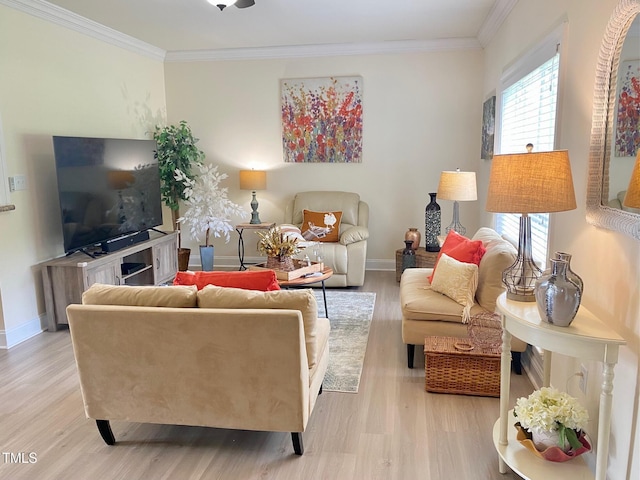 living room with light wood-type flooring, ornamental molding, and baseboards