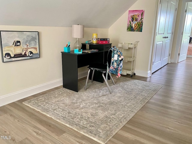 home office with vaulted ceiling, wood finished floors, and baseboards