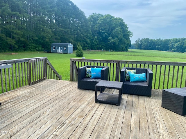 deck with an outbuilding, outdoor lounge area, a yard, and a shed