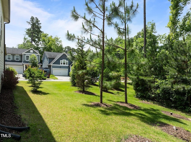 111 Chapel Run Way, Chapel Hill, NC 27517 - view of grassy yard featuring an attached garage and concrete driveway