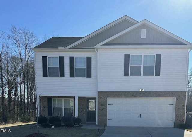 view of front of property with brick siding, driveway, and an attached garage