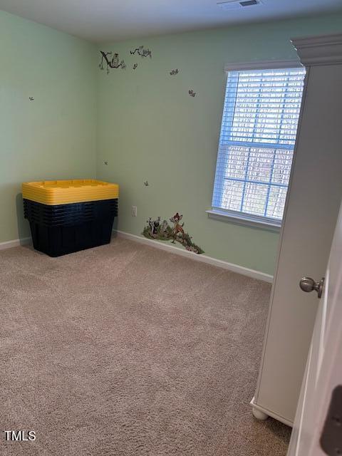 unfurnished bedroom with carpet floors and baseboards