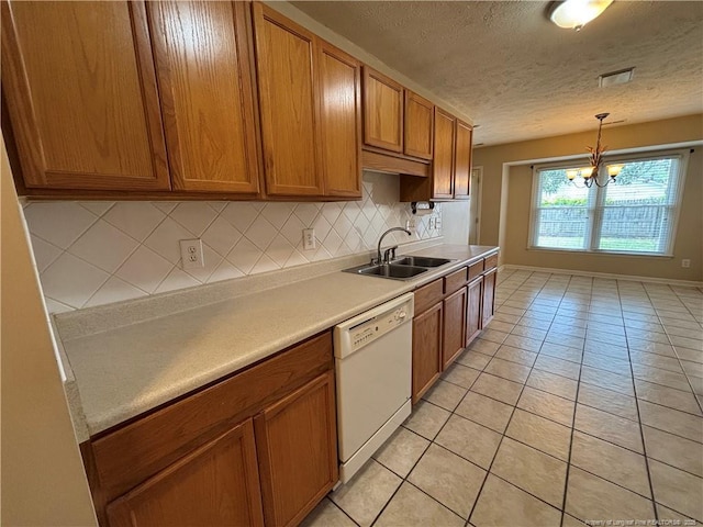 5413 Heather St, Hope Mills, NC 28348 - kitchen with dishwasher, a sink, a textured ceiling, brown cabinetry, and light tile patterned floors