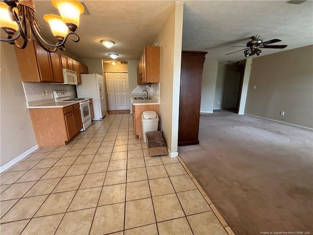 5413 Heather St, Hope Mills, NC 28348 - kitchen with white appliances, a sink, decorative backsplash, light countertops, and open floor plan