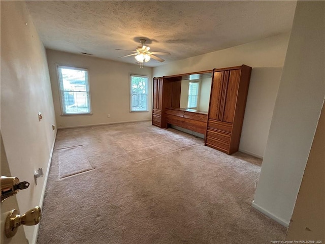 5413 Heather St, Hope Mills, NC 28348 - unfurnished bedroom with light colored carpet, a textured ceiling, baseboards, and ceiling fan