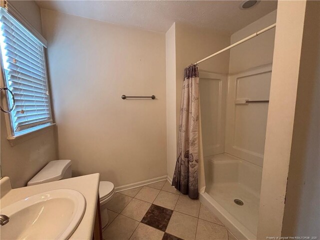 5413 Heather St, Hope Mills, NC 28348 - full bathroom with toilet, curtained shower, vanity, and tile patterned floors
