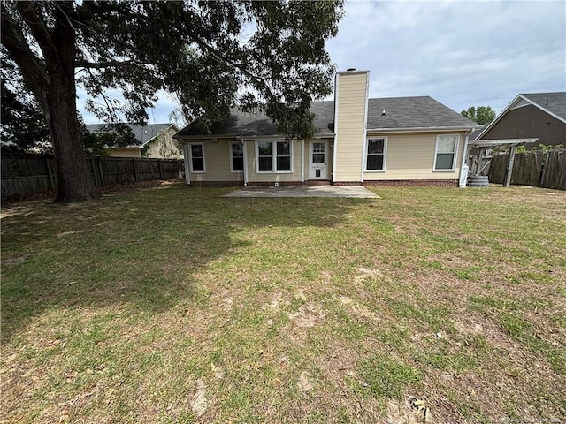 5413 Heather St, Hope Mills, NC 28348 - rear view of house with a chimney and a patio
