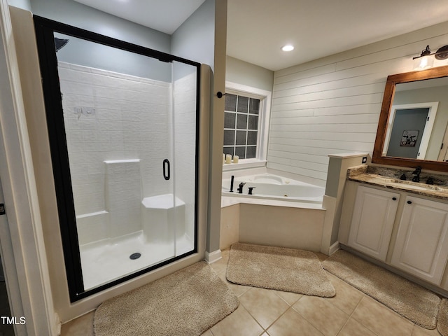 full bathroom featuring tile patterned flooring, a shower stall, a whirlpool tub, vanity, and recessed lighting