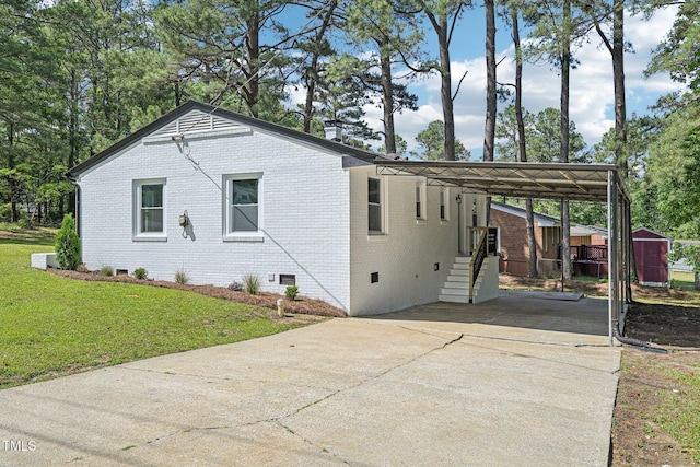 view of property exterior with crawl space, concrete driveway, brick siding, a lawn, and a carport