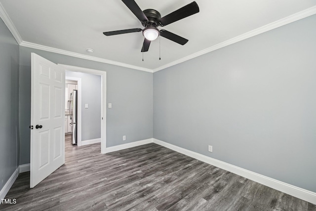 unfurnished bedroom with baseboards, dark wood-style flooring, ornamental molding, ceiling fan, and freestanding refrigerator