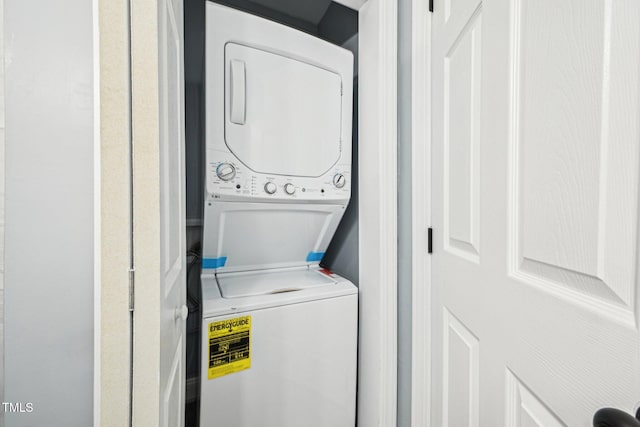 washroom featuring stacked washer / dryer