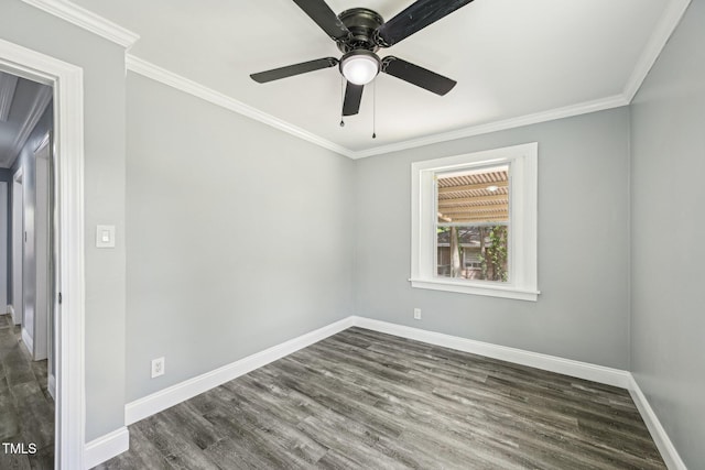 spare room featuring wood finished floors, baseboards, ornamental molding, and a ceiling fan