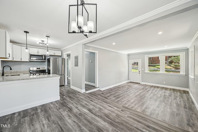 kitchen with stainless steel appliances, crown molding, baseboards, dark wood finished floors, and white cabinets