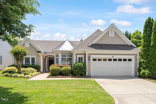 view of front facade with an attached garage, driveway, a front lawn, and a shingled roof