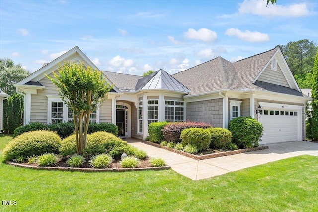 view of front of property featuring an attached garage, a front yard, a shingled roof, and concrete driveway