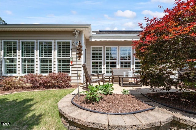 rear view of house featuring a patio area, solar panels, and a yard