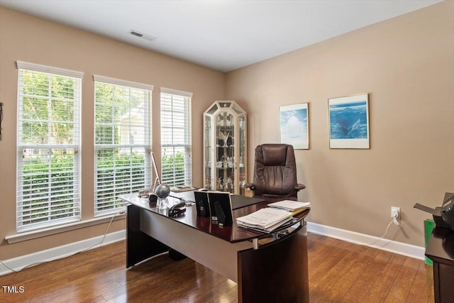 office space featuring baseboards and wood-type flooring