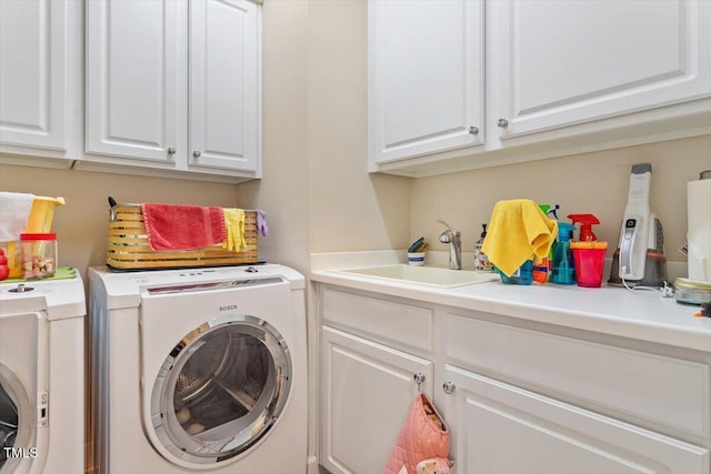 washroom with washing machine and clothes dryer and cabinet space