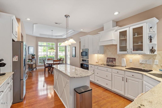 kitchen with stainless steel appliances, white cabinets, tasteful backsplash, light wood finished floors, and recessed lighting