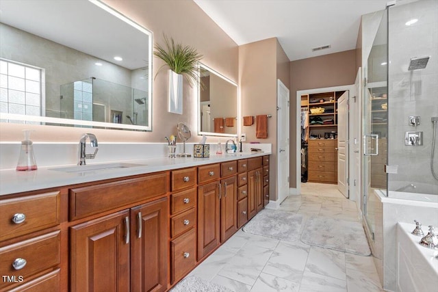 full bathroom with marble look tiles, a stall shower, a walk in closet, a garden tub, and double vanity