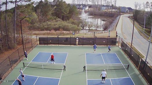view of tennis court featuring fence