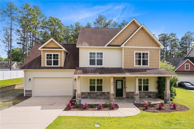 craftsman-style home with concrete driveway, covered porch, and stone siding
