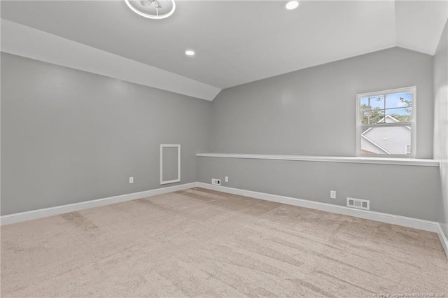 carpeted spare room featuring lofted ceiling, baseboards, and recessed lighting
