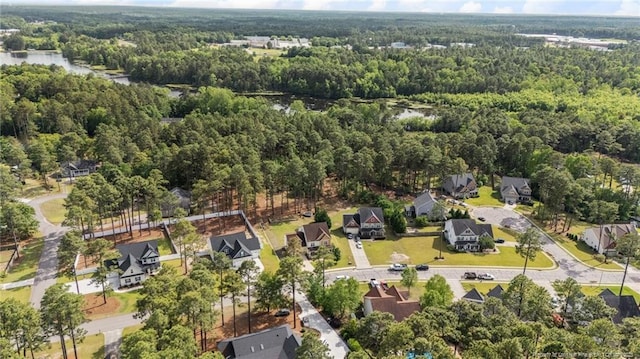 aerial overview of property's location with a forest and a nearby body of water