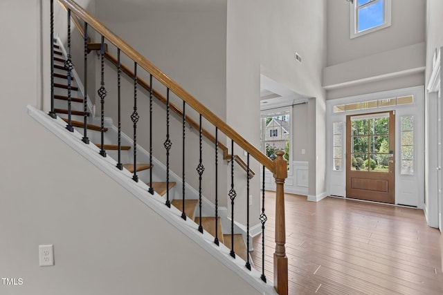 entrance foyer featuring stairway, wood finished floors, and baseboards