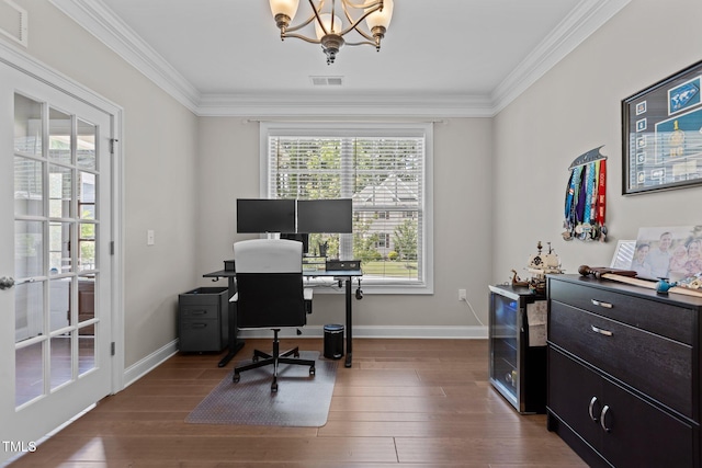 office featuring a chandelier, ornamental molding, baseboards, and wood finished floors