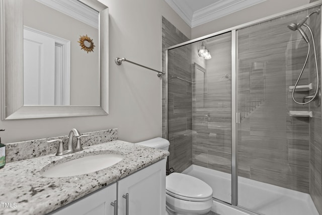 full bath with toilet, ornamental molding, a shower stall, and vanity