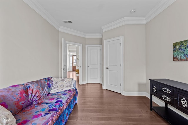 living room with crown molding, wood finished floors, and baseboards
