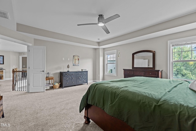 carpeted bedroom featuring multiple windows, baseboards, and ceiling fan