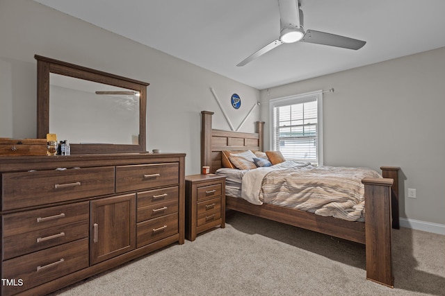 bedroom with light carpet and ceiling fan