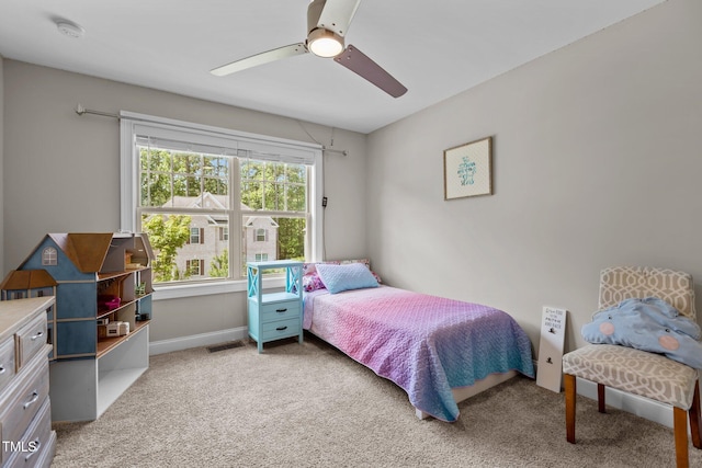 carpeted bedroom featuring a ceiling fan and baseboards