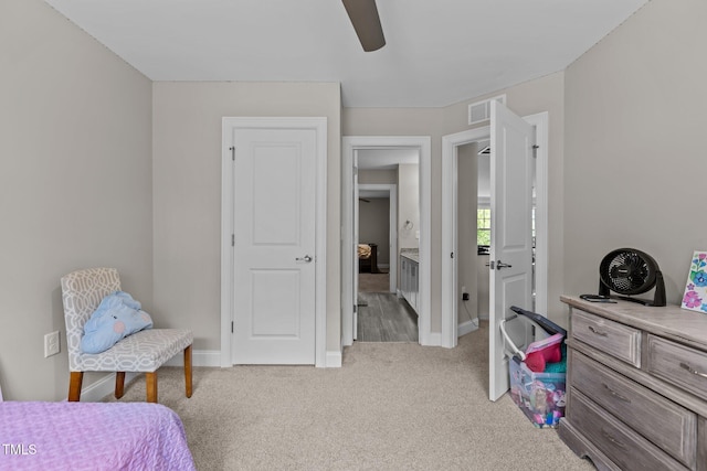 bedroom with light colored carpet, baseboards, and a ceiling fan